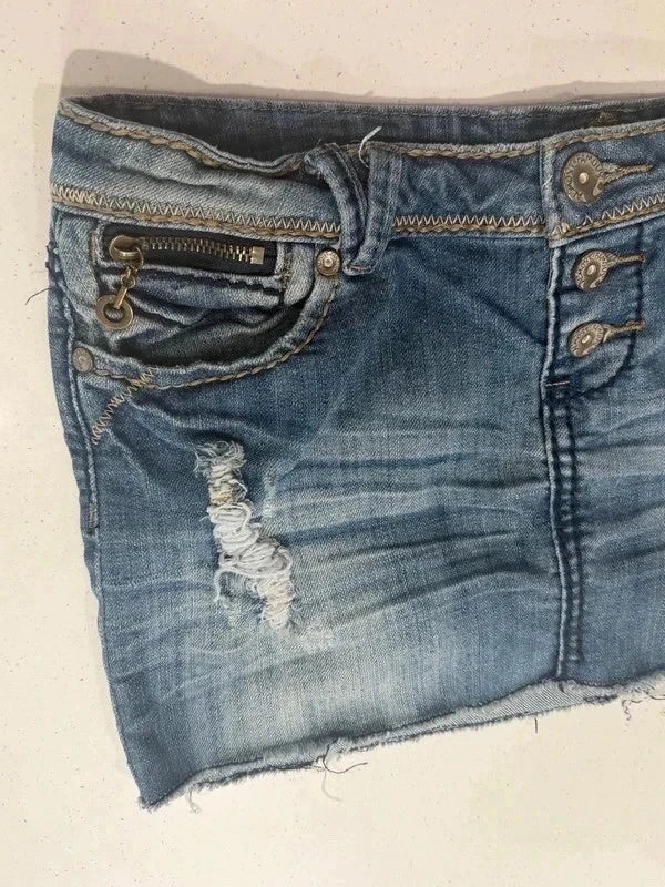 Almost Famous distressed denim micro mini skirt, side angle showing distressing and zip pocket