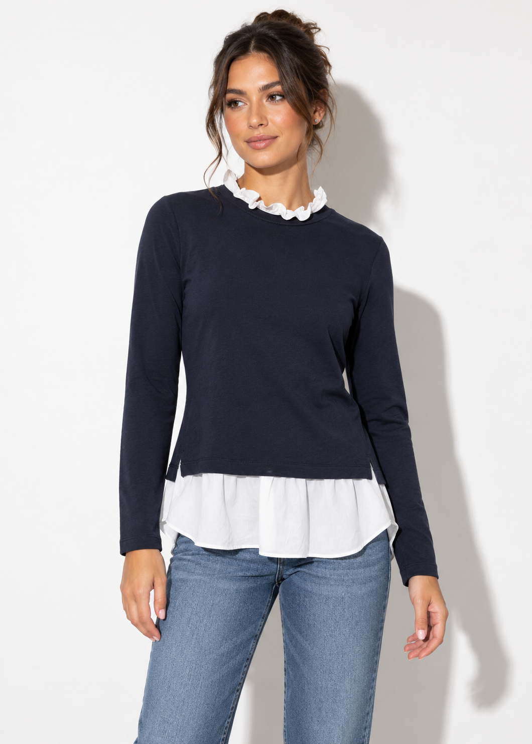 Front view of Ann Taylor navy and white ruffle layered top styled with blue jeans