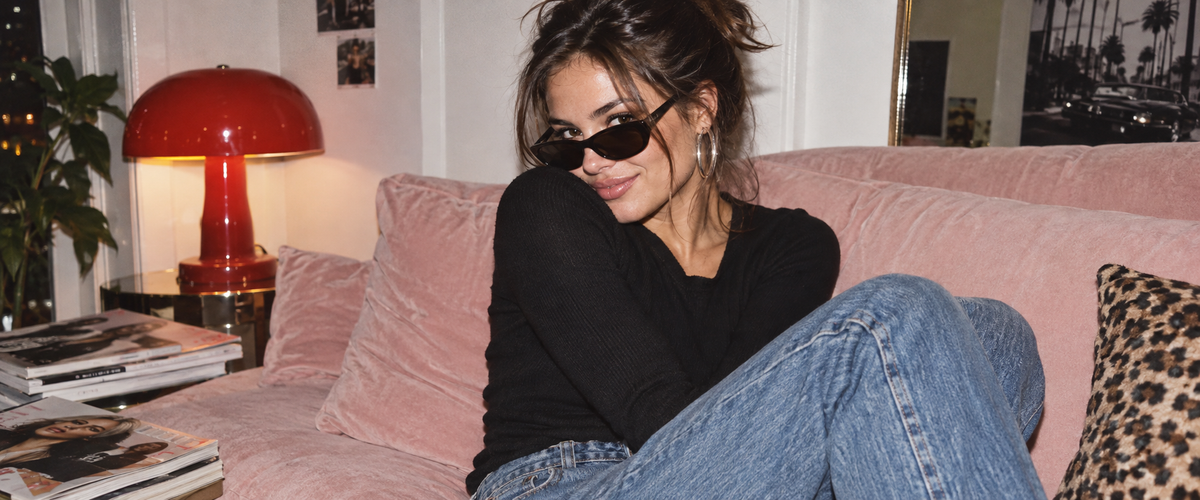 Fashion editorial model on a pink sofa