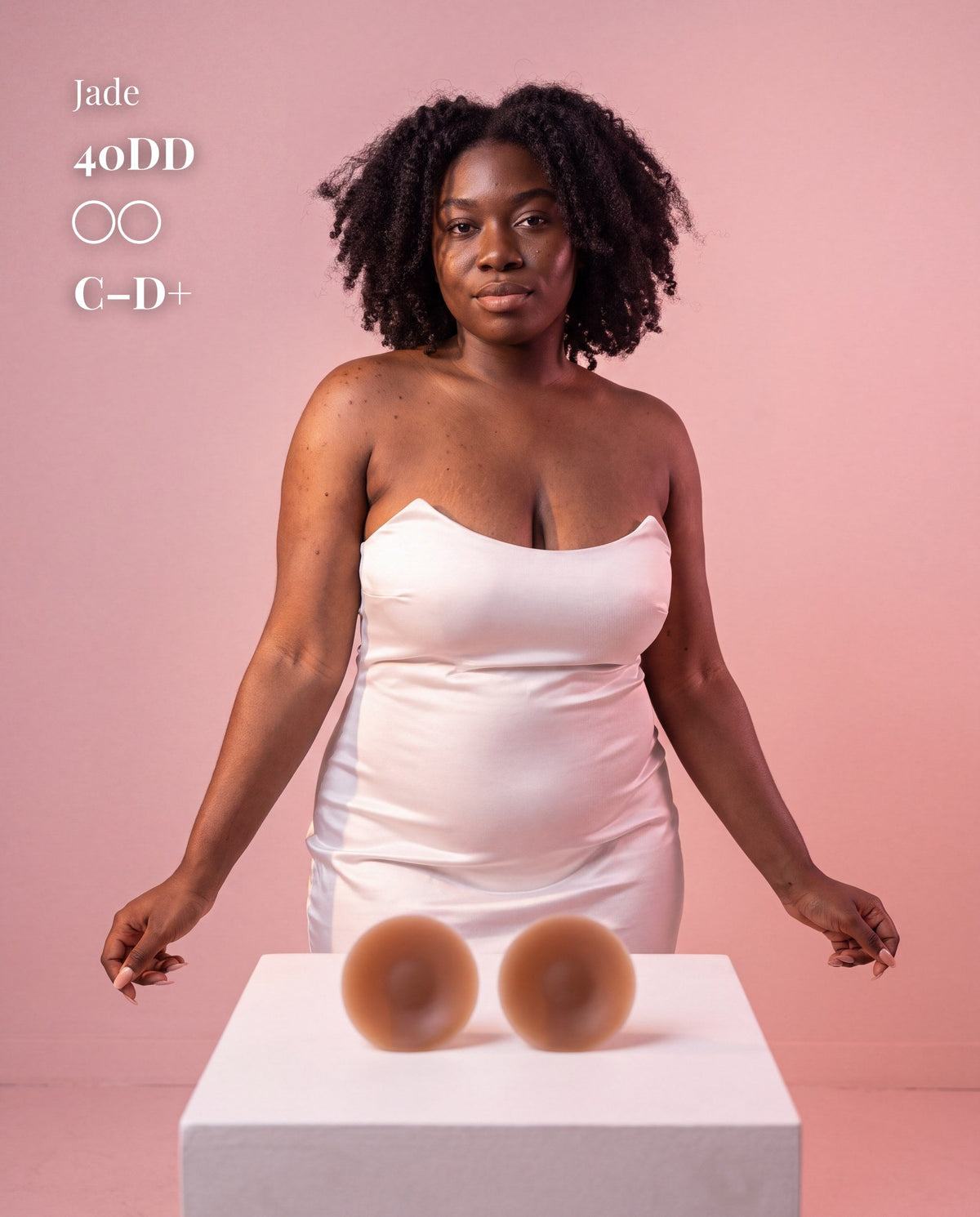 Model in a white strapless dress with Sticky Boobs dark covers for C-D+ cups