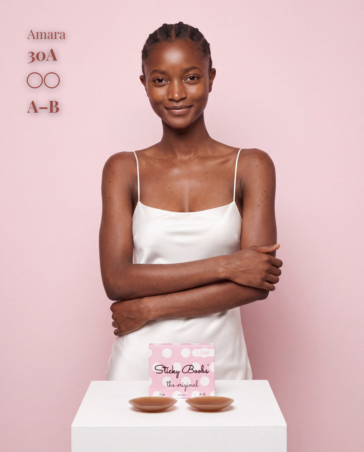 Model in a white satin slip with Sticky Boobs dark nipple covers, size A-B
