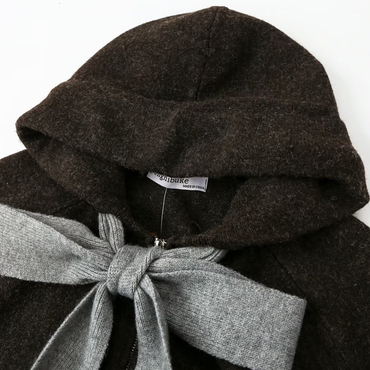 Close-up of the hood and oversized gray bow on the Cecily dark brown cardigan