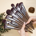 Hand fanning out the Bueart Design 19-piece chocolate makeup brush set
