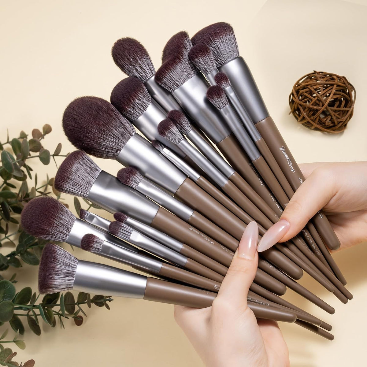 Hand fanning out the Bueart Design 19-piece chocolate makeup brush set