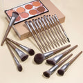 Bueart Design chocolate makeup brushes laid out beside an eyeshadow palette