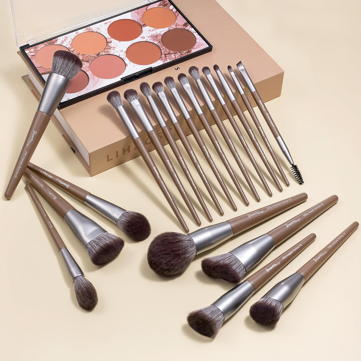 Bueart Design chocolate makeup brushes laid out beside an eyeshadow palette