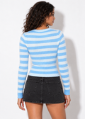 Back view of the Maren blue striped zip cardigan with black denim skirt
