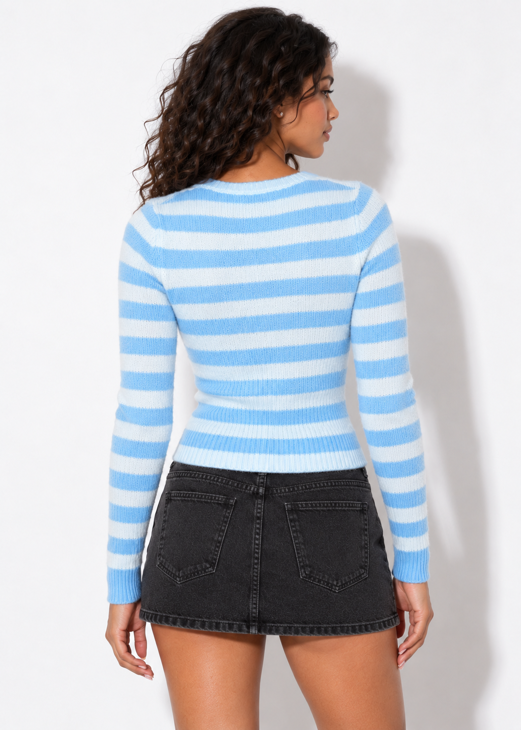 Back view of the Maren blue striped zip cardigan with black denim skirt