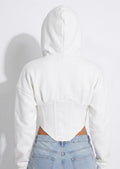Back view of the white cropped zip corset hoodie showing the hood and seaming