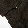 Detail of the zipper and ribbed hem on the Cecily dark brown knit cardigan