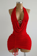 Red halter neck dress on a mannequin with a plain background