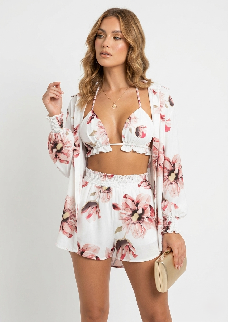 Woman wearing a floral two-piece set with a matching cardigan on a white background