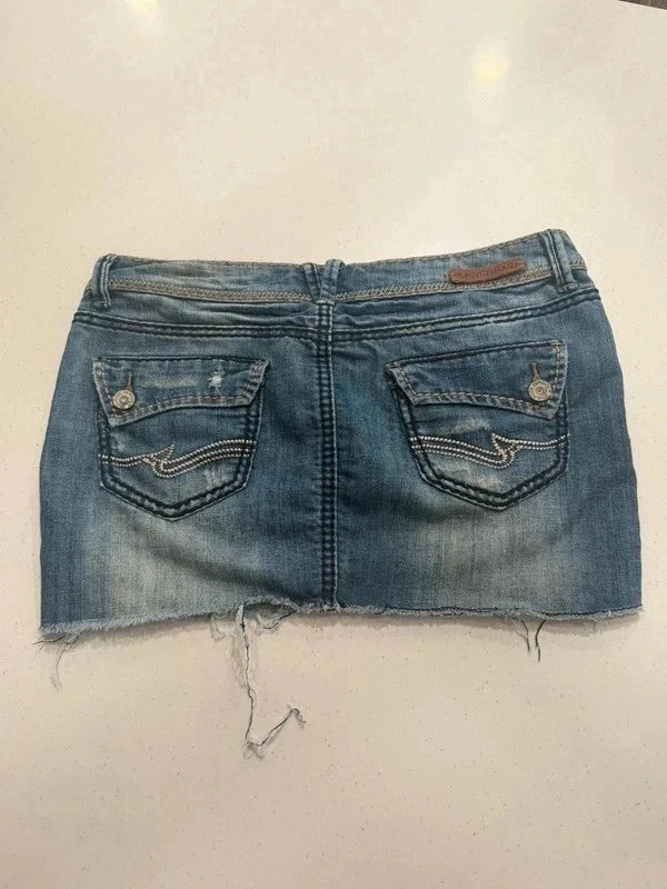 Almost Famous distressed denim micro mini skirt, back view with flap pockets