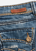 Almost Famous denim skirt close-up of brown brand patch, contrast stitching and back pocket button