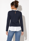 Back view of Ann Taylor navy and white ruffle layered top showing keyhole neckline