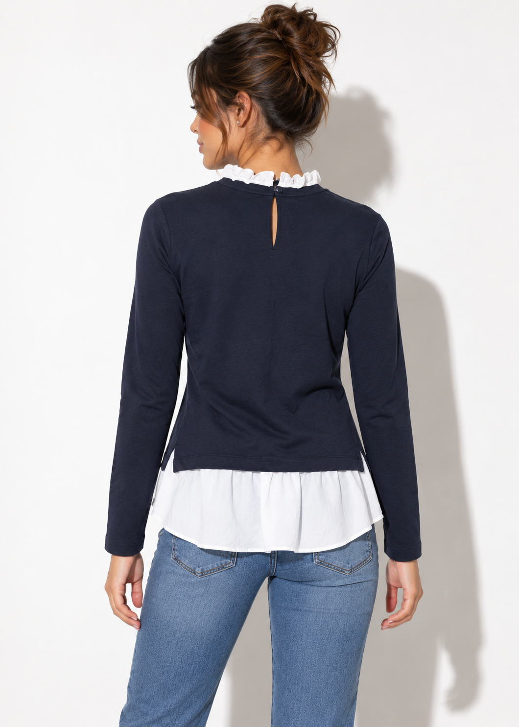 Back view of Ann Taylor navy and white ruffle layered top showing keyhole neckline