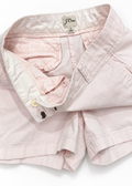 Close-up of the J.Crew light pink chino shorts waistband, button and label