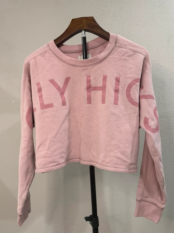 Gilly Hicks pink cropped graphic sweatshirt, front view on hanger