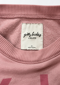 Gilly Hicks pink cropped sweatshirt, brand and size label close-up
