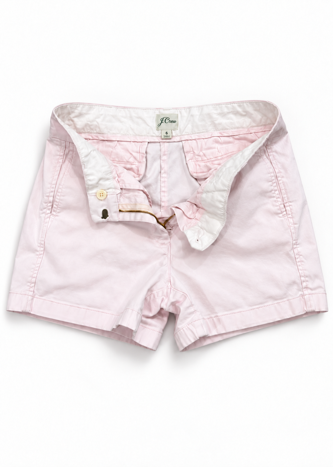 J.Crew light pink chino shorts closure and size 6 label detail on white studio background