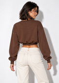 Keely cropped sweatshirt in brown, back view styled with ecru jeans