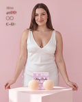 Model in a white satin dress showing Sticky Boobs covers for C-D+ cups