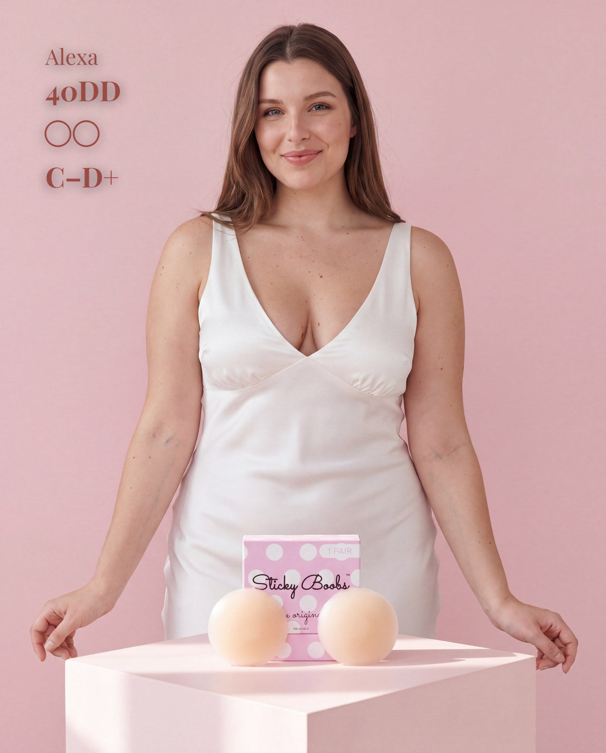 Model in a white satin dress showing Sticky Boobs covers for C-D+ cups