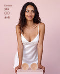Model in a white satin slip with Sticky Boobs nipple covers, cup size A-B