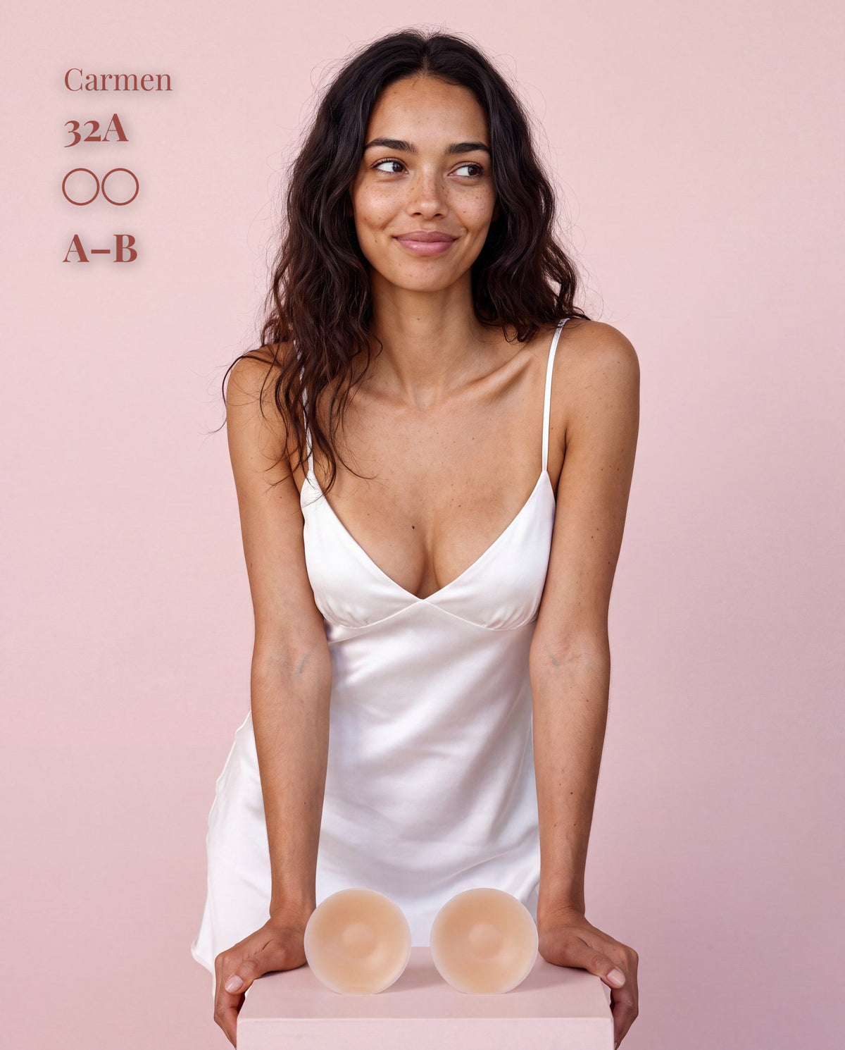 Model in a white satin slip with Sticky Boobs nipple covers, cup size A-B