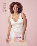 Smiling model in a white satin dress with Sticky Boobs covers for C-D+ cups