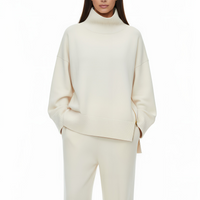 Woman wearing a cream-colored outfit on a white background