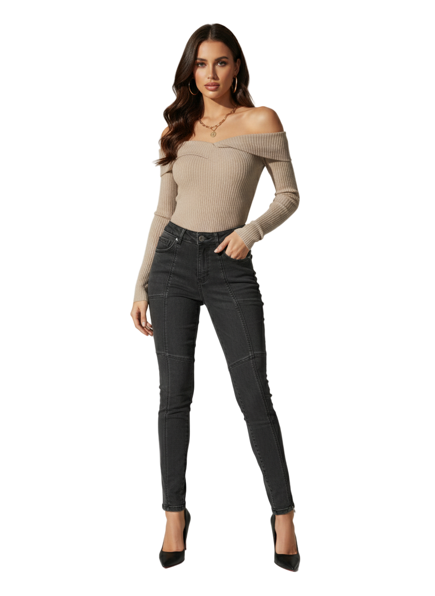 Woman wearing a beige off-shoulder top and black jeans on a white background