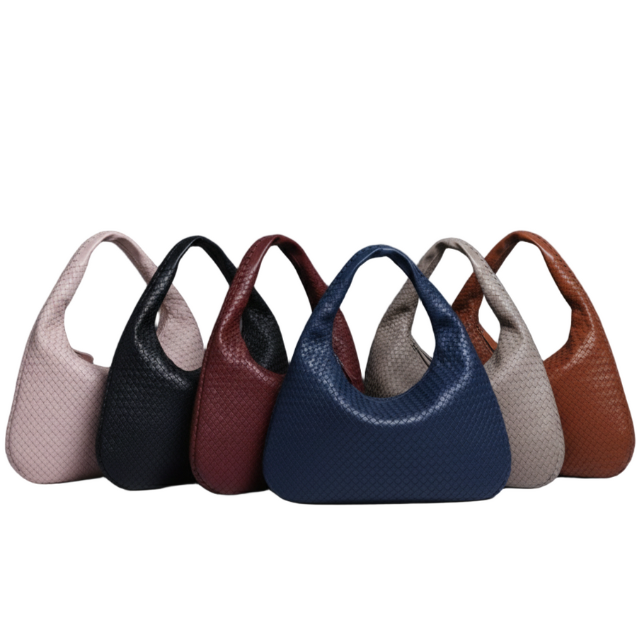 Row of handbags in various colors on a gray background